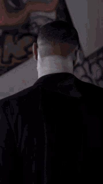 a man with a skull face paint and blood on his shirt