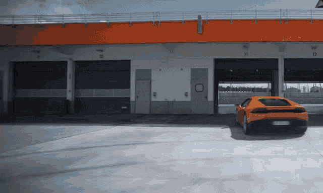 an orange sports car is parked in front of a building with numbers 11 12 and 13