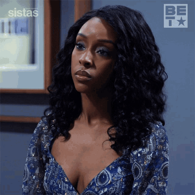 a woman in a blue dress with the word sistas on the bottom right
