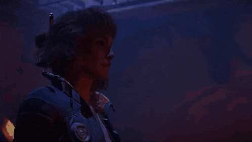 a man in a blue jacket is standing in front of a painting of han solo