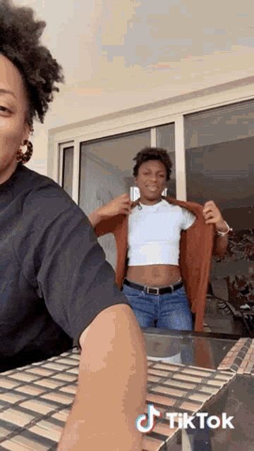 a tiktok video of a woman taking off a man 's shirt .