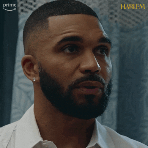 a close up of a man 's face with the word harlem on the corner