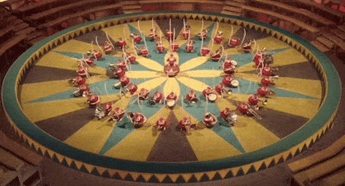 a group of people are playing instruments in a circular pattern