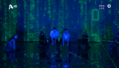 a group of people are dancing on a stage with a hd logo on the bottom