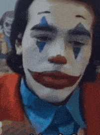a close up of a person dressed as a clown with a blue eye