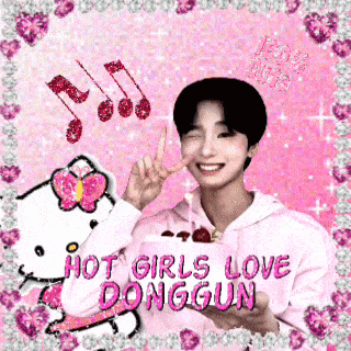 a boy in a pink hoodie is holding a hello kitty cake and giving a peace sign .