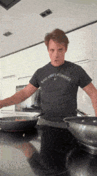 a man wearing a bad vibes forever t-shirt is cooking