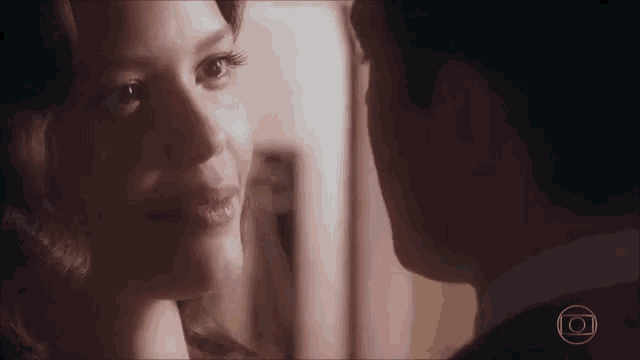 a man and a woman are looking into each other 's eyes with a circle in the middle