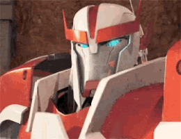 a close up of a robot with blue eyes and a helmet .