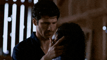 a man is touching a woman 's face in a close up