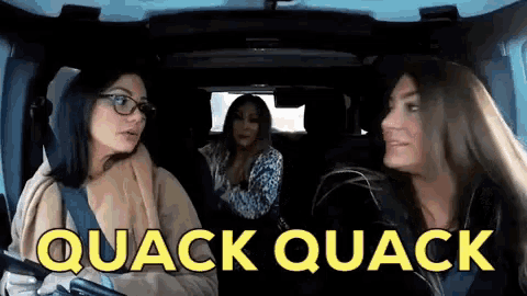 three women in a car with the words quack quack written in yellow