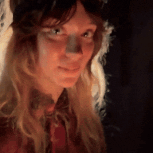a close up of a woman 's face with long hair