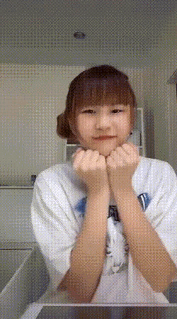 a girl wearing a white shirt that says ' i love you ' on the front