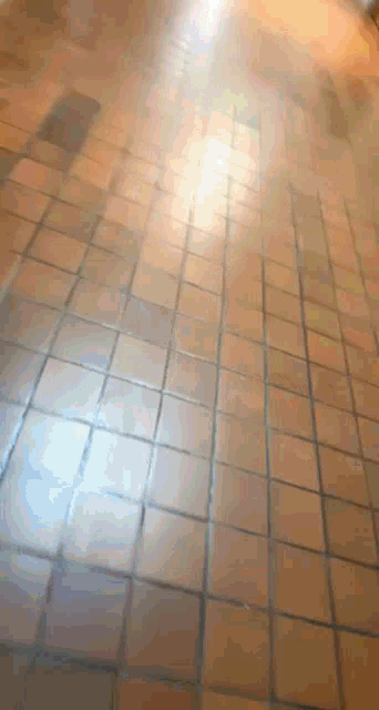 a tiled floor with a light shining through the tiles