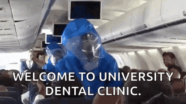 a person in a protective suit is on a plane .