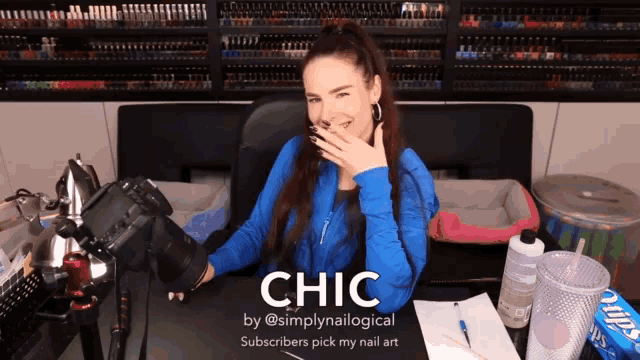 a woman sitting at a desk with a camera and the word chic on the bottom