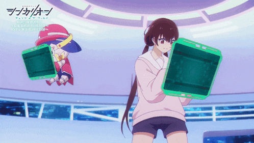 a girl in a pink sweater is holding a green box while another girl in a red hat is sitting behind her