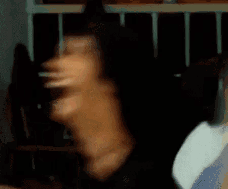 a blurry picture of a man laughing with a yellow object in his mouth .