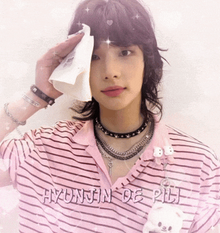 a person wearing a pink shirt that says hyonjun de rii on it