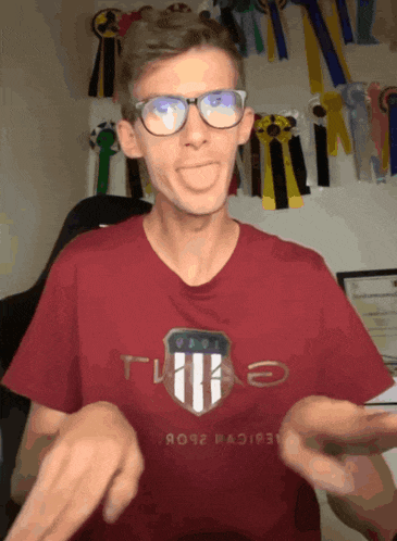 a man wearing glasses and a red t-shirt that says tlk