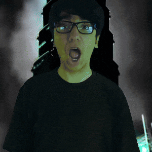 a man wearing glasses and a black shirt has his mouth wide open