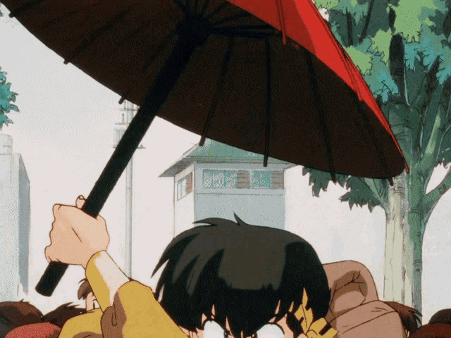 a person is holding a red umbrella in the rain