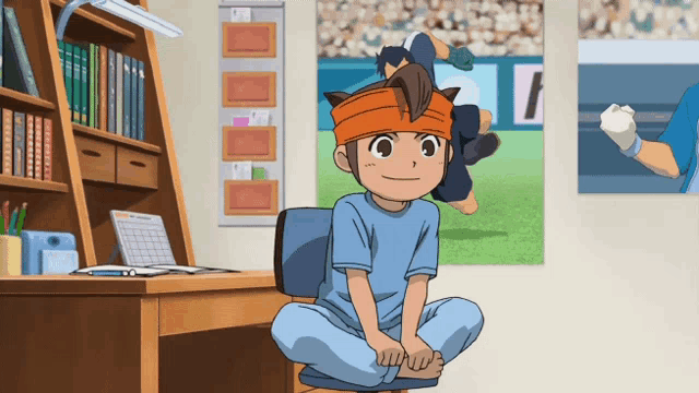 a boy in a blue shirt sits on a chair in a room