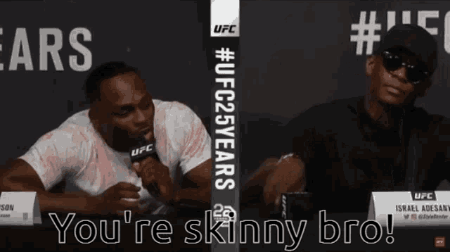 two men are sitting at a table with the words you 're skinny bro