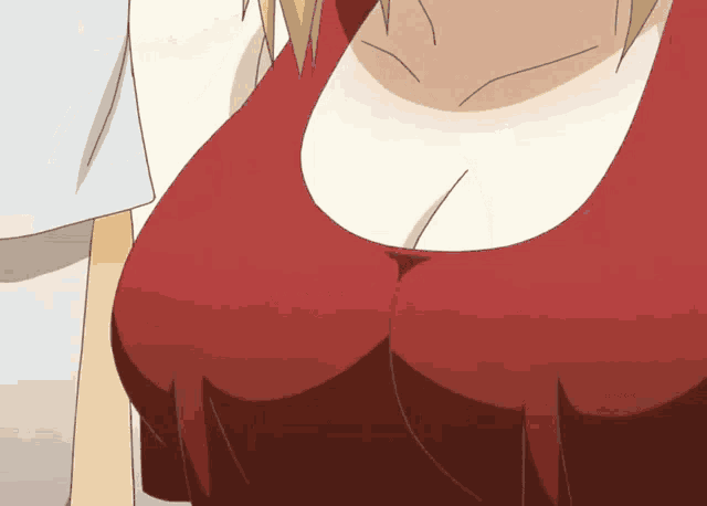 a close up of a woman 's breasts in a red shirt