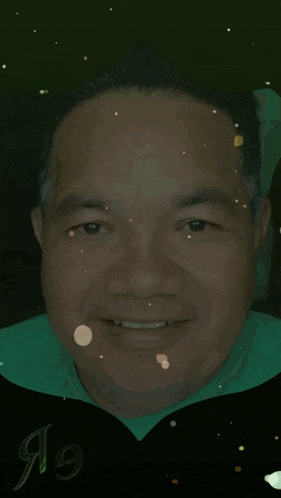 a man wearing a green shirt and a black cape with the year 1991 on it