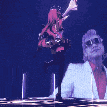 a girl in a red dress is dancing in front of a man in a white suit