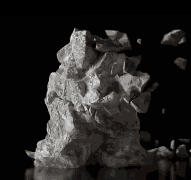 a pile of crumpled paper on a black surface .