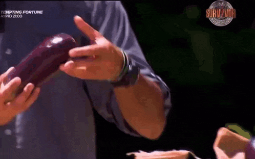 a man is holding an apple in his hands with a survivor logo in the background ..