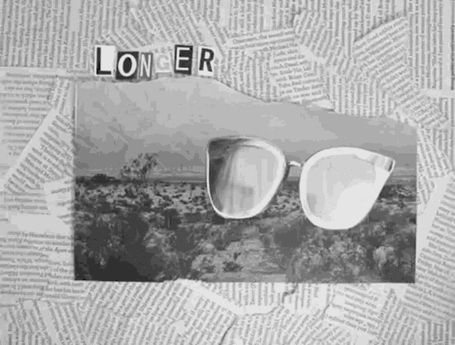 a pair of sunglasses is sitting on top of a pile of newspaper with the word longer cut out of it .
