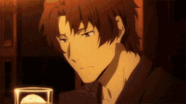 a man with red hair is holding a glass