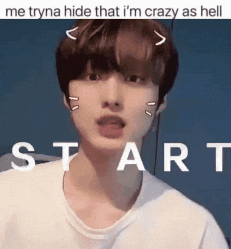 a young man with a cat ear on his head is standing in front of a sign that says start