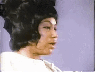 a close up of a woman 's face with a wig on her head