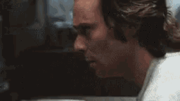 a close up of a man 's face with his mouth open