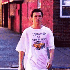 a man wearing a white shirt that says " i survived my trip to nyc "