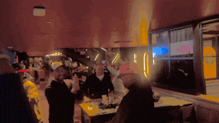 a group of people are gathered in a room with a burger king sign on the wall