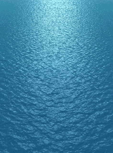 a close up of a blue water surface with the sun shining through it