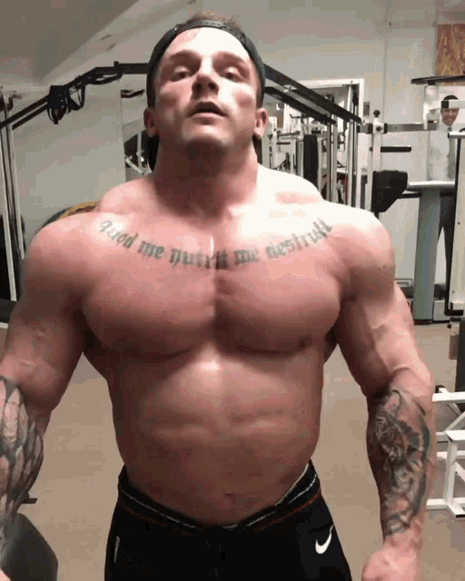 a man has a tattoo on his chest that says " god me built me destroyed "