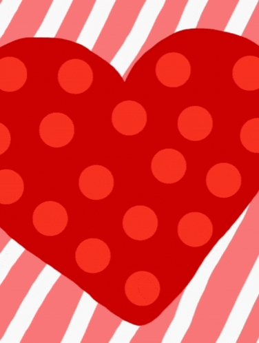 a red heart with red polka dots and a white heart in the middle