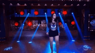 a woman 's legs are shown in a blurry photo with a sbt logo in the corner