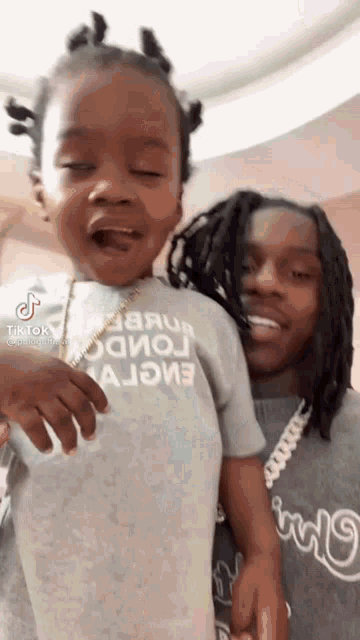a man and a little girl are standing next to each other .