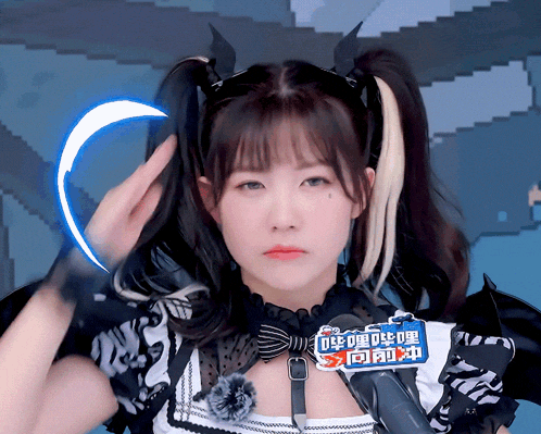 a girl with pigtails has a sign on her neck that says ' chinese '