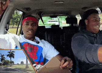 a man wearing a nike headband sits in a car