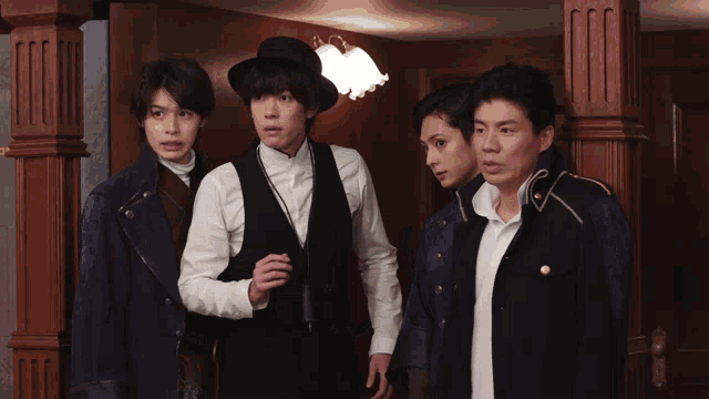 a group of men standing next to each other in a hallway