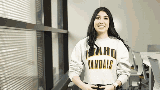 a woman wearing an idaho vandals sweatshirt smiles