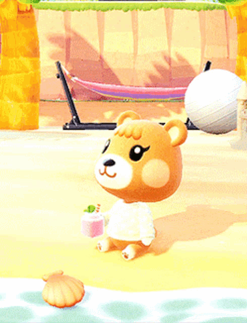 a teddy bear is holding a pink box on a beach